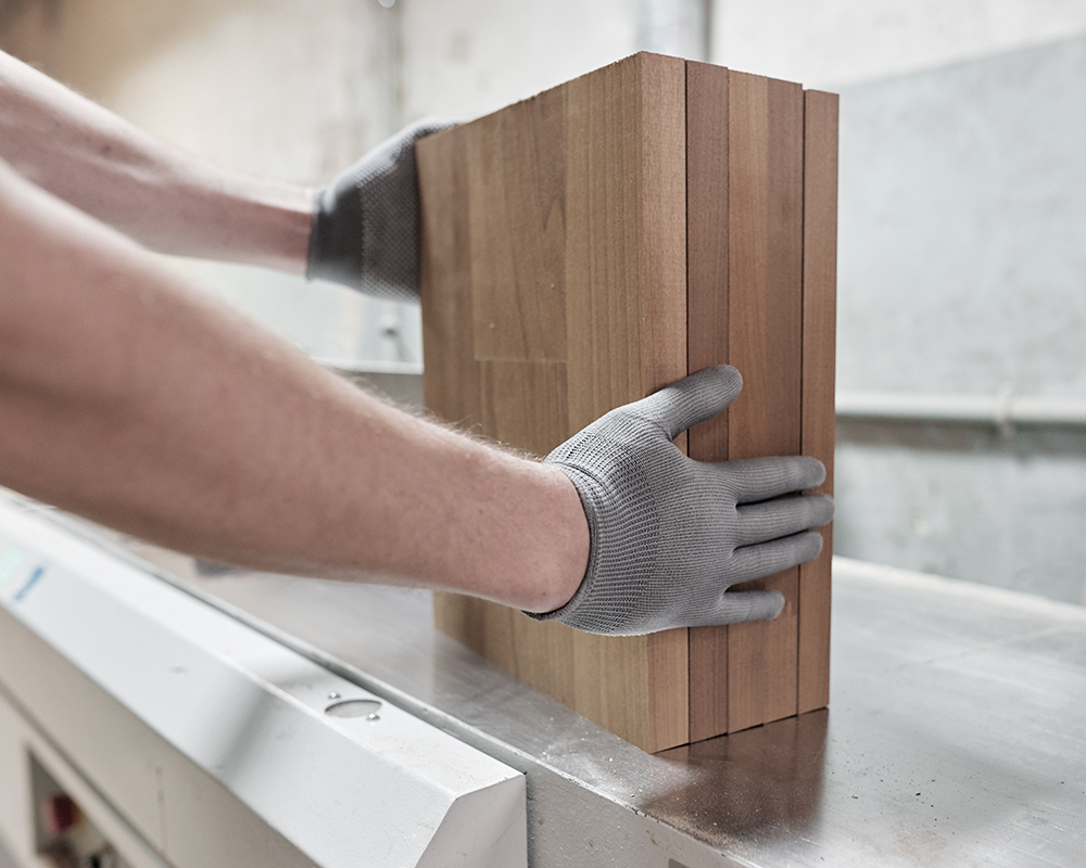 a worker hands holding casework panels small structure